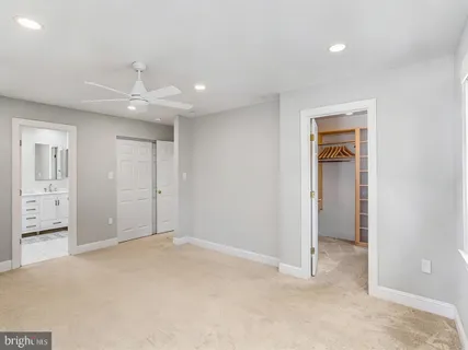 an empty room with closet and a bathroom