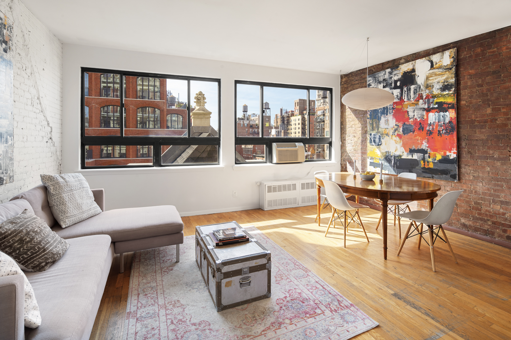 a living room with furniture a flat screen tv and a floor to ceiling window