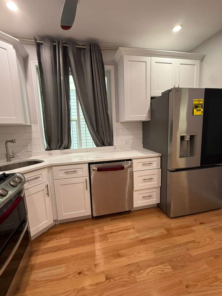 641 East 4th Street, Unit 1 Brooklyn, NY 11218 - Photo 2 of 15 a kitchen with granite countertop a refrigerator and a stove top oven
