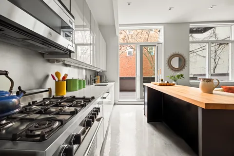 a kitchen with stainless steel appliances granite countertop a stove and a sink