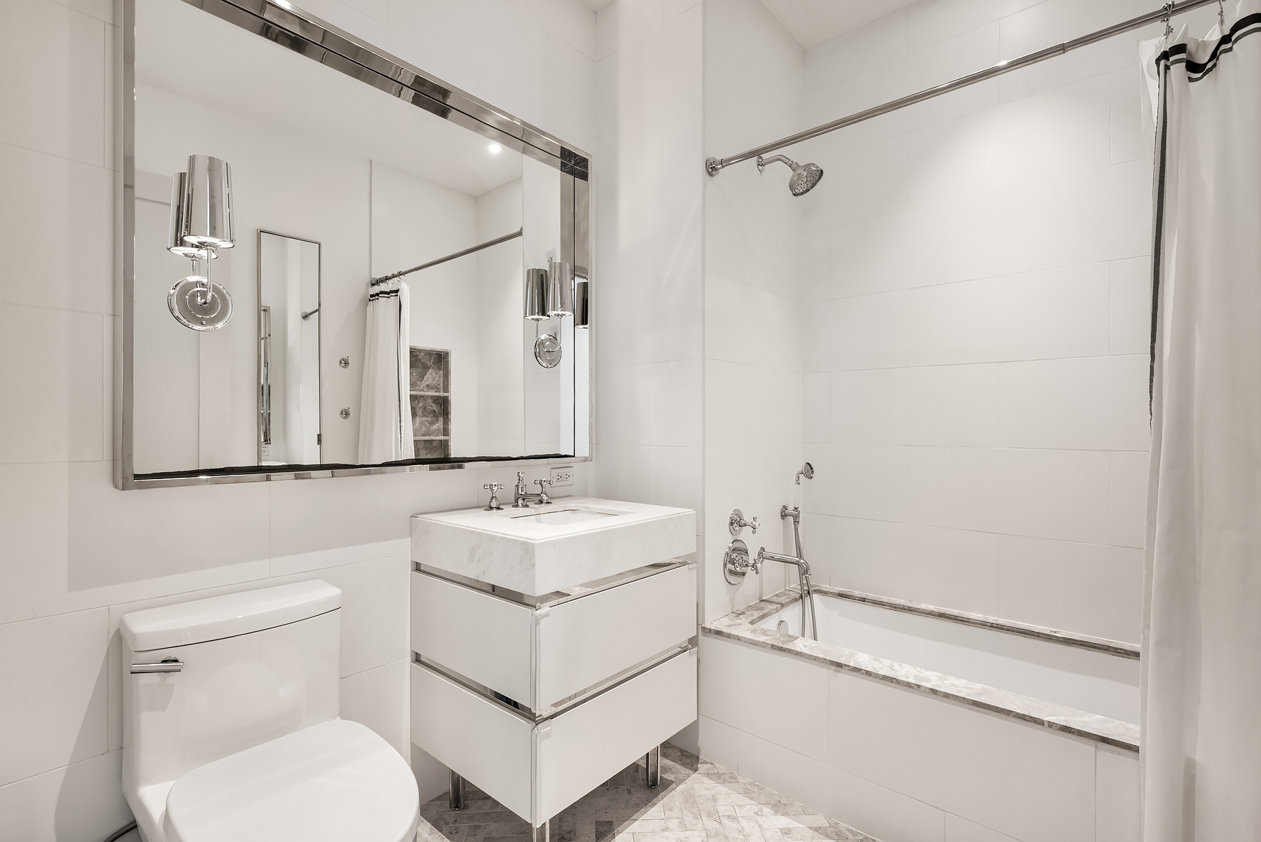 308 North 7th Street, Unit 7E Brooklyn, NY 11211 - Photo 7 of 13 a bathroom with a sink toilet vanity and shower