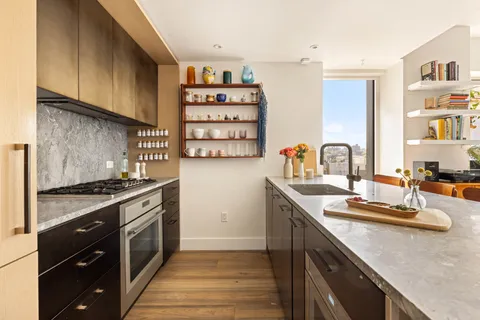 a kitchen with a stove and cabinets