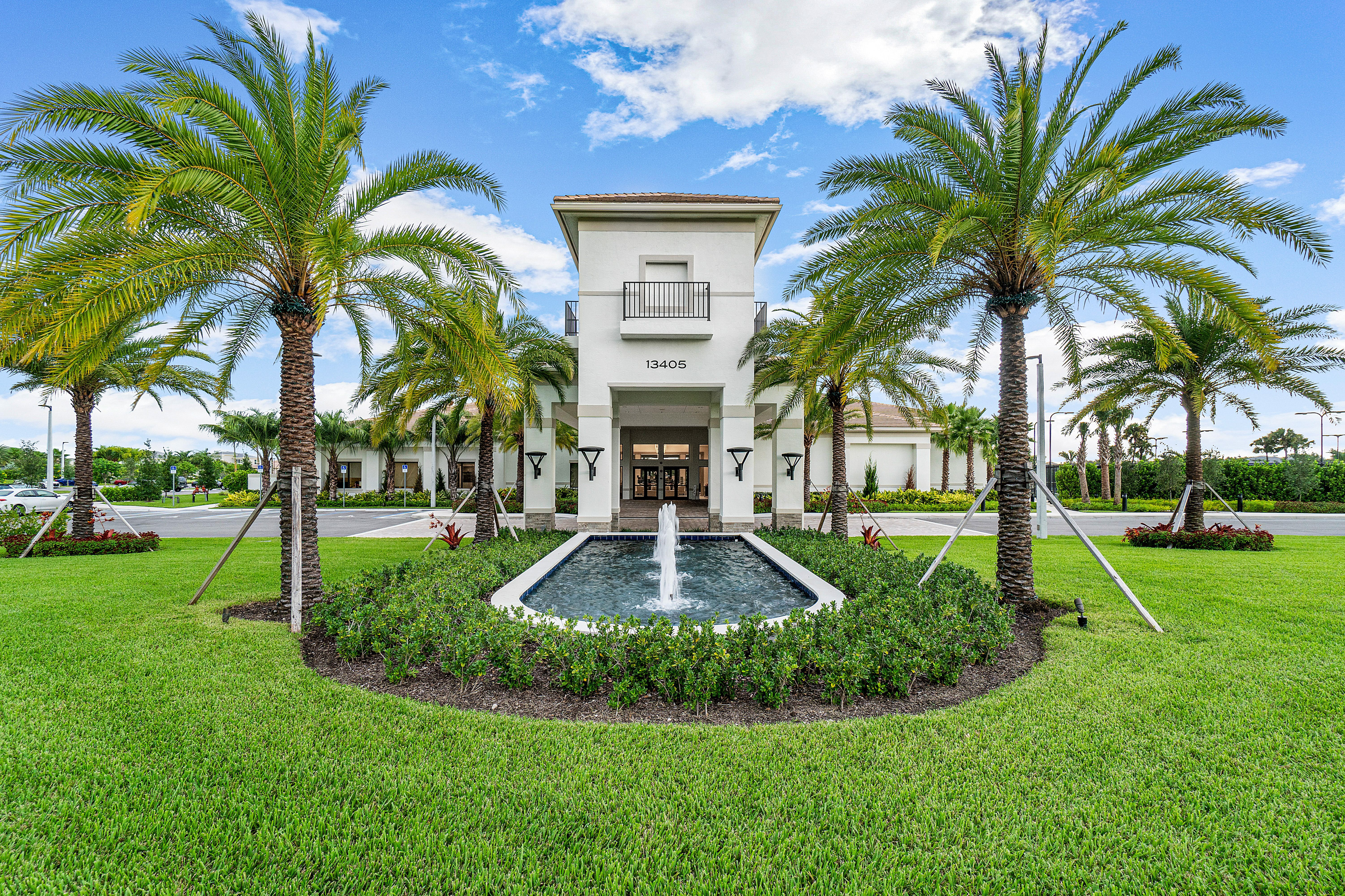 13172 Whistler Mountain Road Delray Beach, FL 33446 - Photo 30 of 38 a front view of multi story residential apartment building with yard and green space