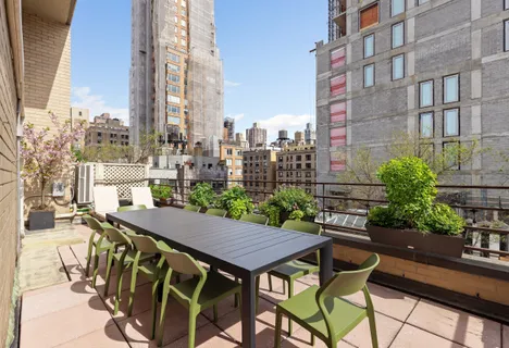 a spacious bedroom with a bed and a lamp