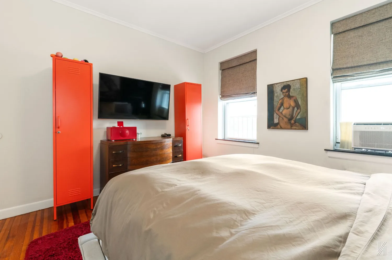 a bedroom with a bed and a flat screen tv