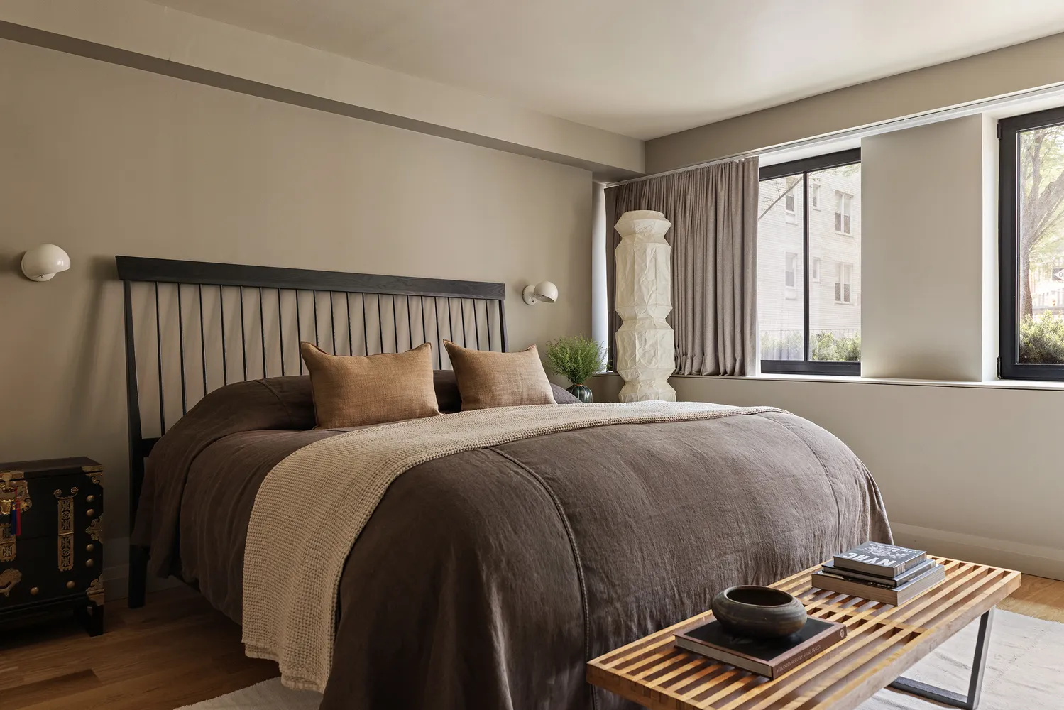 a bed sitting in a bedroom next to a window