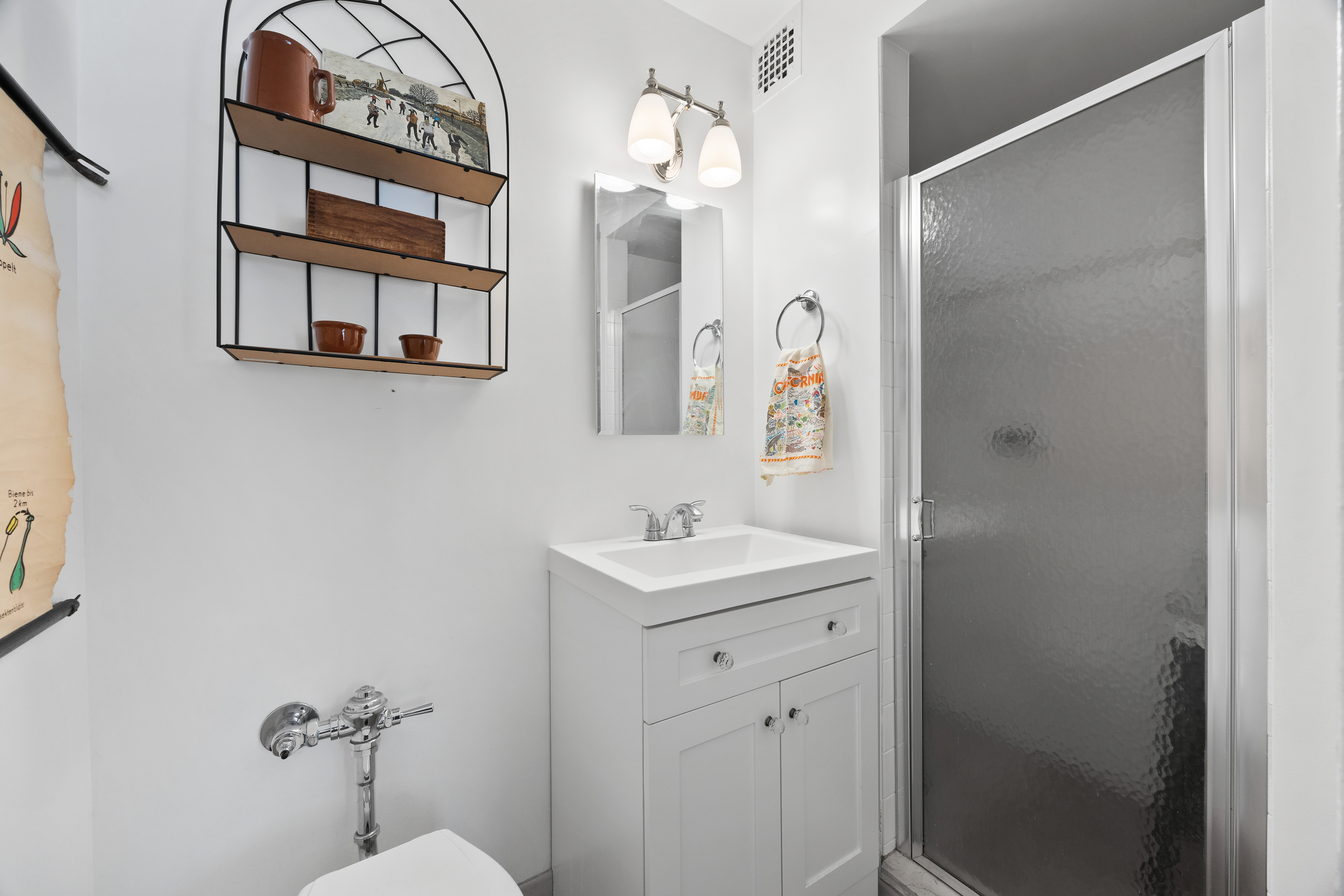 255 Fieldston Terrace, Unit 2L Bronx, NY 10471 - Photo 21 of 32 a bathroom with a sink a mirror a vanity and a shower