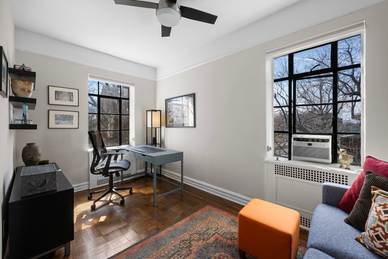 a view of a livingroom with workspace and a window