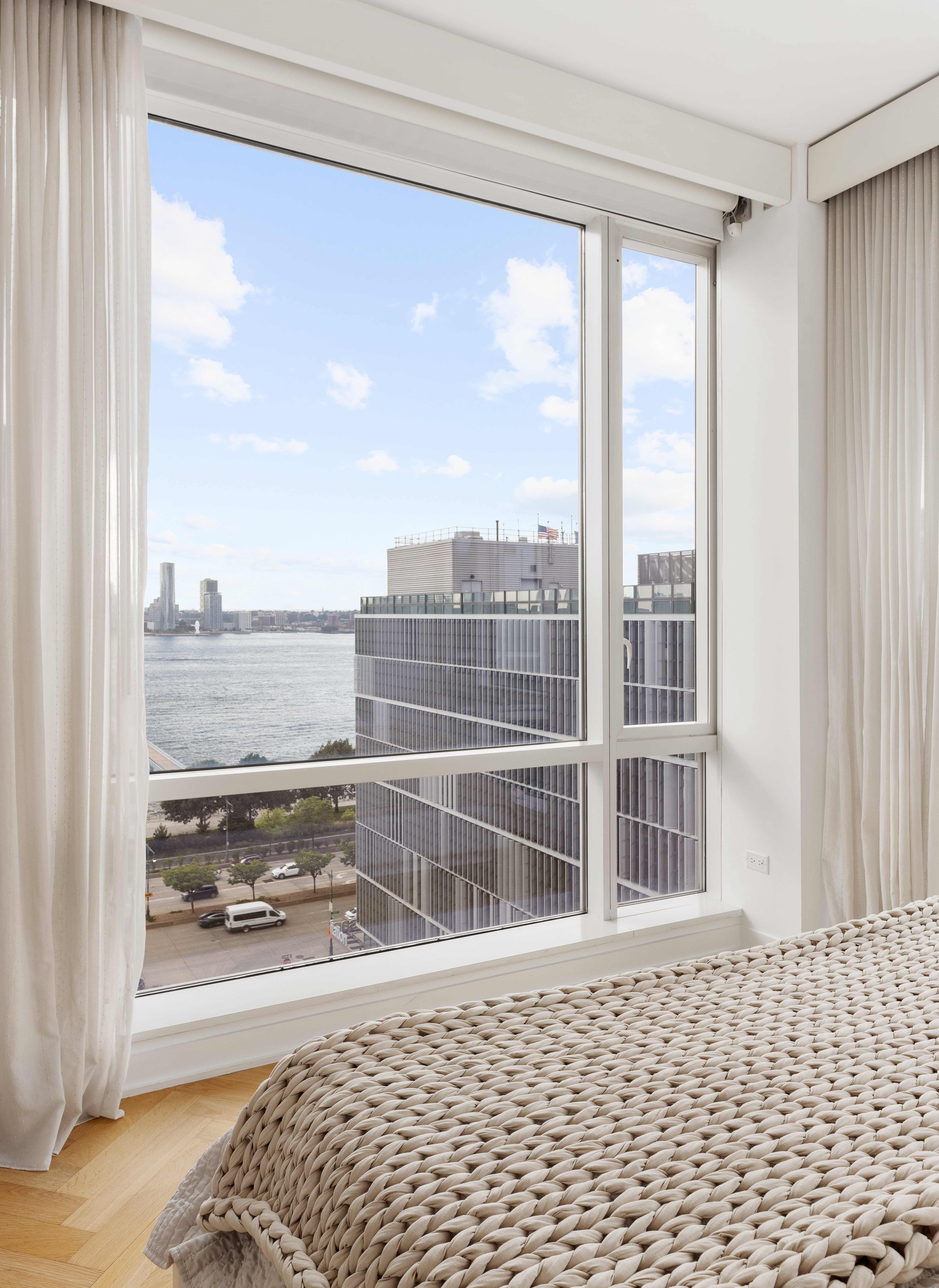 330 Spring Street, Unit 11B Manhattan, NY 10013 - Photo 7 of 10 a view of a floor to ceiling window and wooden floor