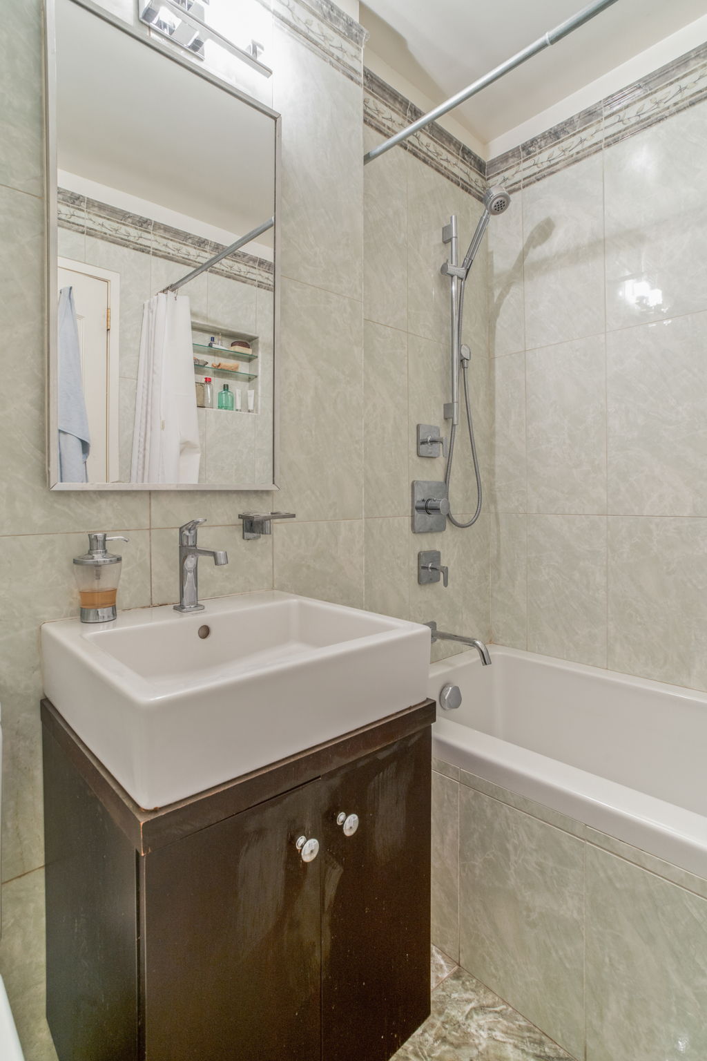 30 East 65th Street, Unit 3B Manhattan, NY 10065 - Photo 9 of 12 a bathroom with a sink bath tub and a shower