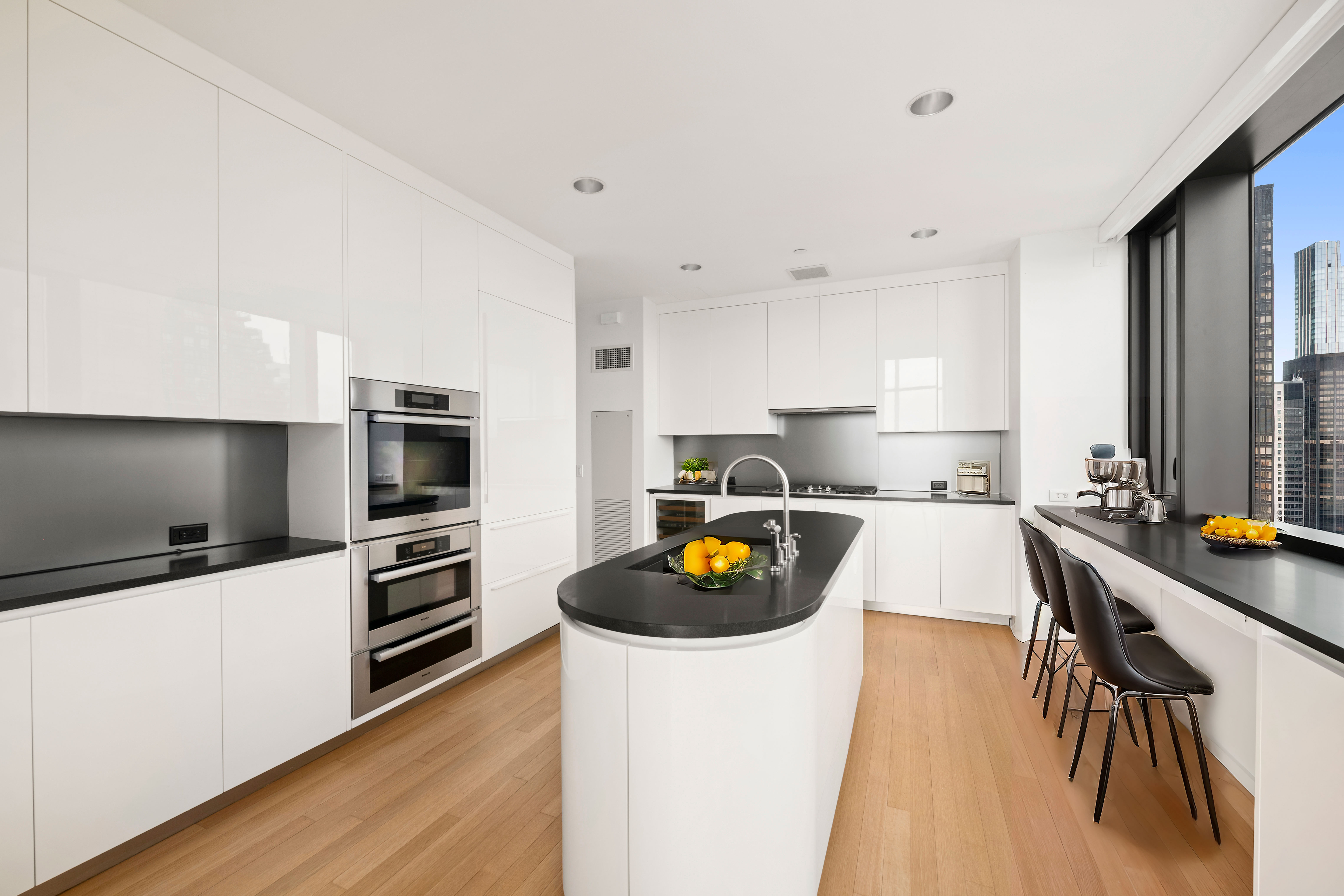 50 United Nations Plaza, Unit 34B Manhattan, NY 10017 - Photo 4 of 17 a kitchen with stainless steel appliances a stove a sink a refrigerator and cabinets