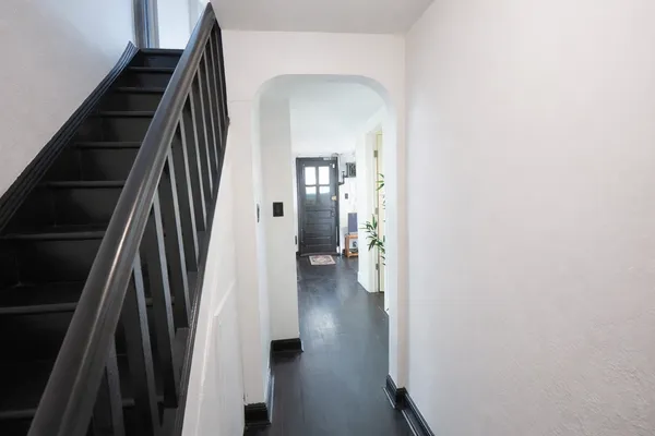 a view of an entryway with wooden floor