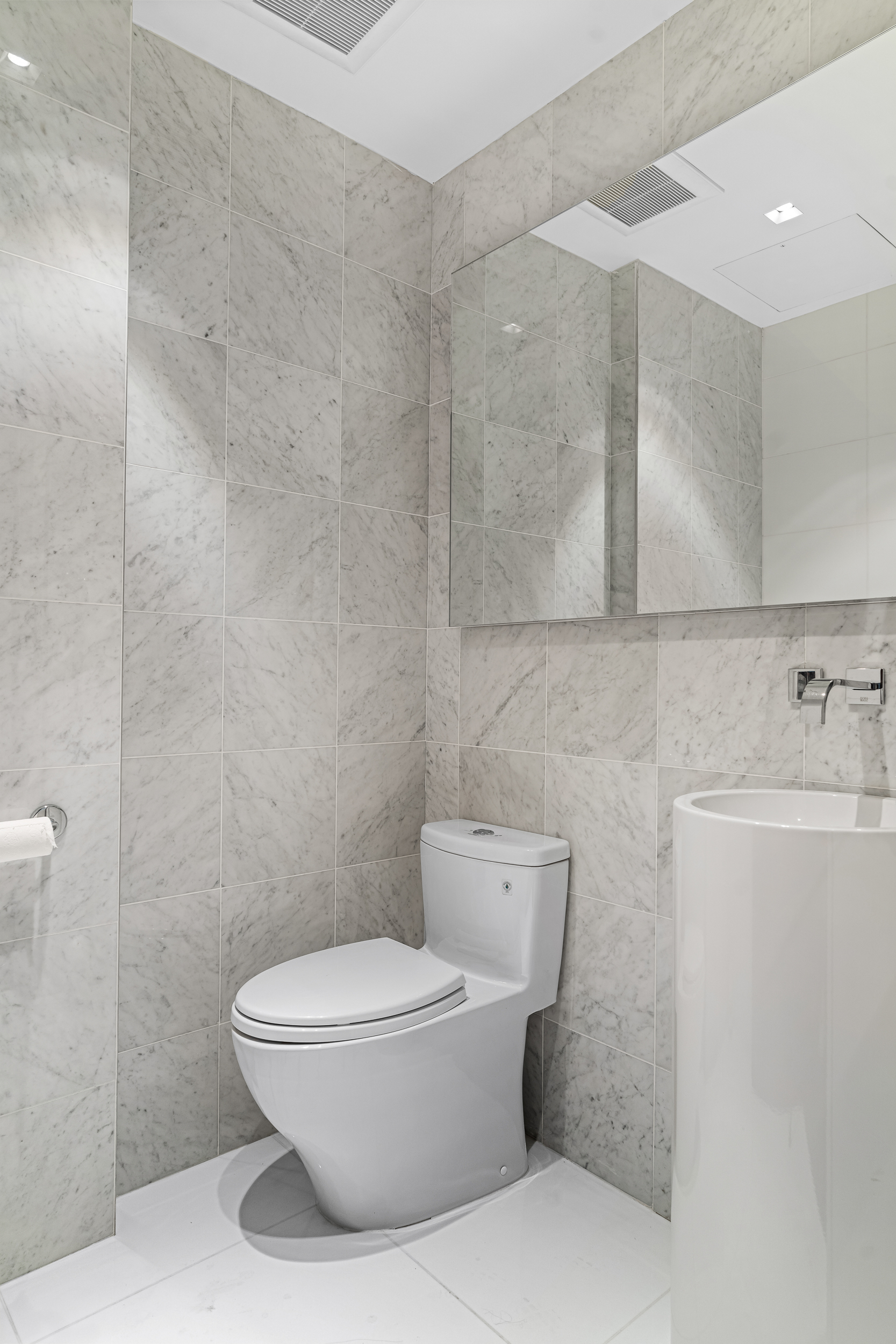 135 East 38th Street Manhattan, NY 10016 - Photo 29 of 32 a white toilet sitting next to a bathroom sink