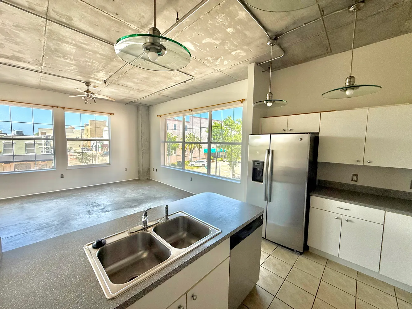 a kitchen with stainless steel appliances granite countertop a sink a counter space cabinets and appliances