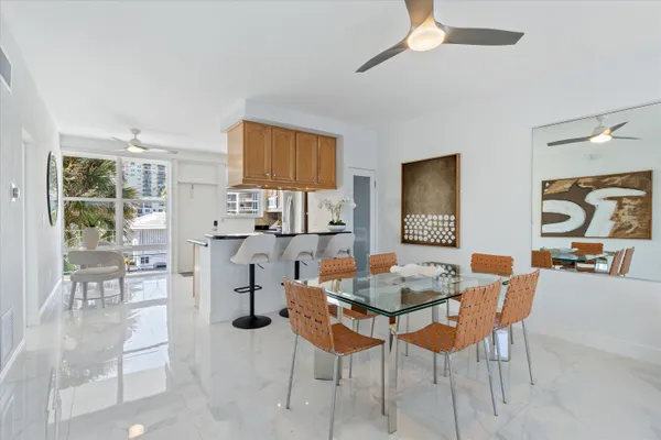 a dining room with furniture and wooden floor