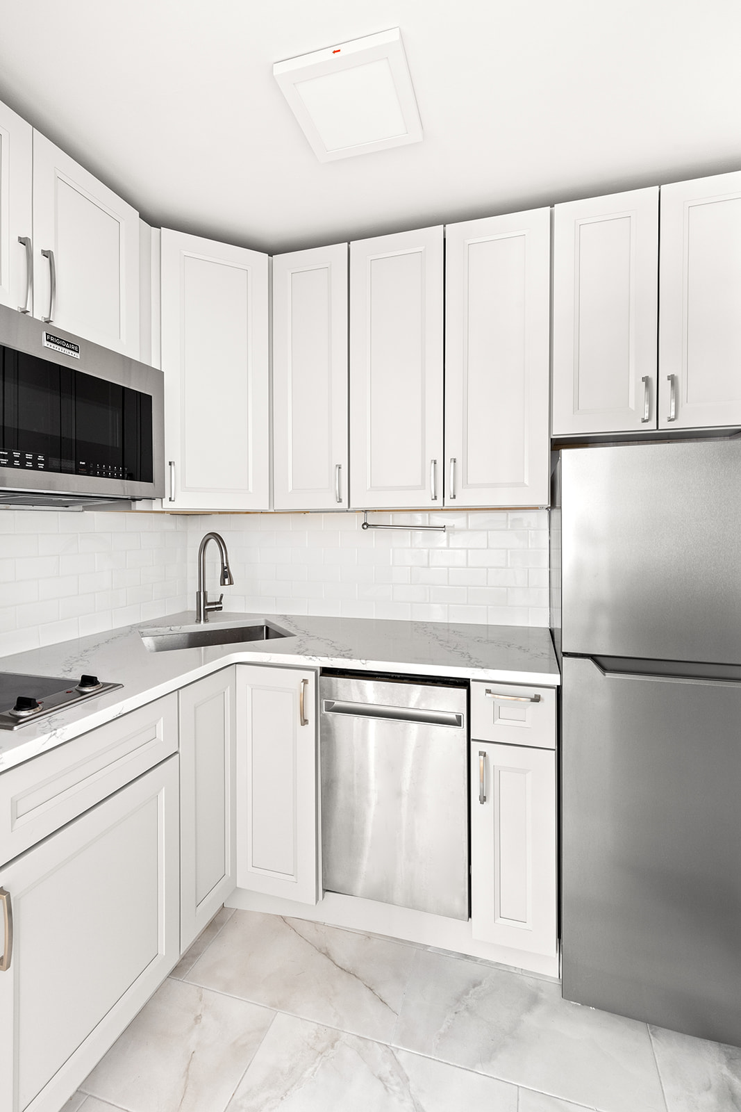 338 Prospect Place, Unit 1F Brooklyn, NY 11238 - Photo 3 of 6 a kitchen with white cabinets and white appliances