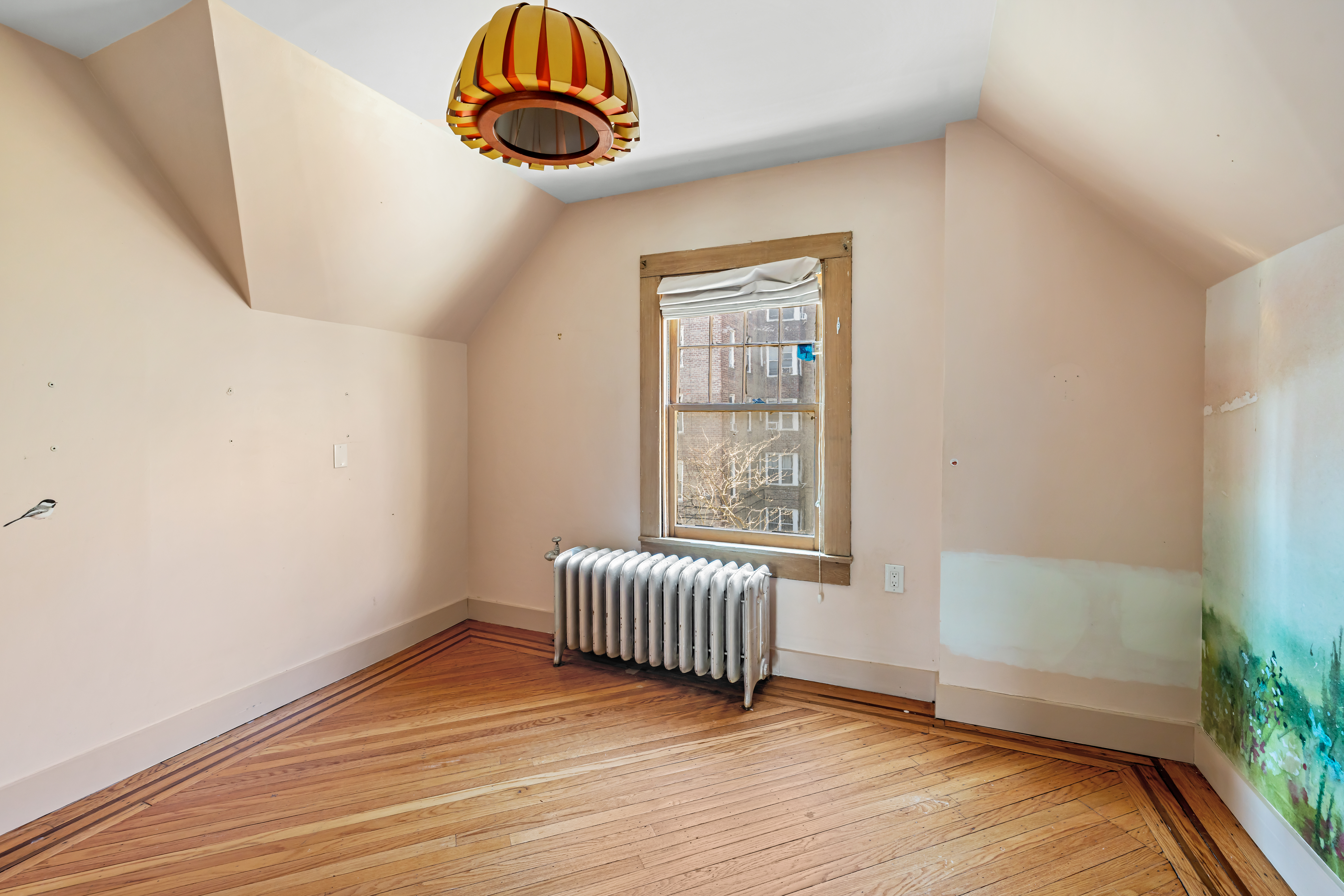 792 East 21st Street Brooklyn, NY 11210 - Photo 22 of 29 an empty room with wooden floor and windows