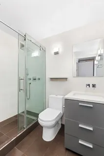 a bathroom with a toilet a sink and shower