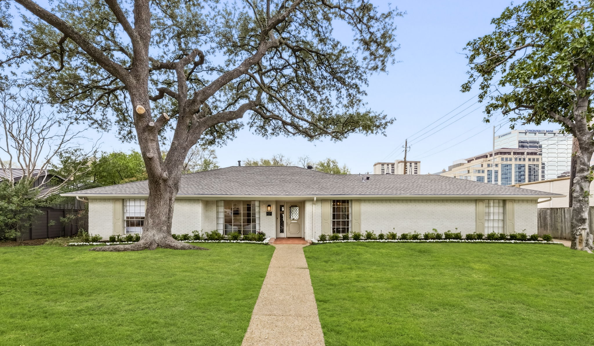 a front view of a house with a garden and yard