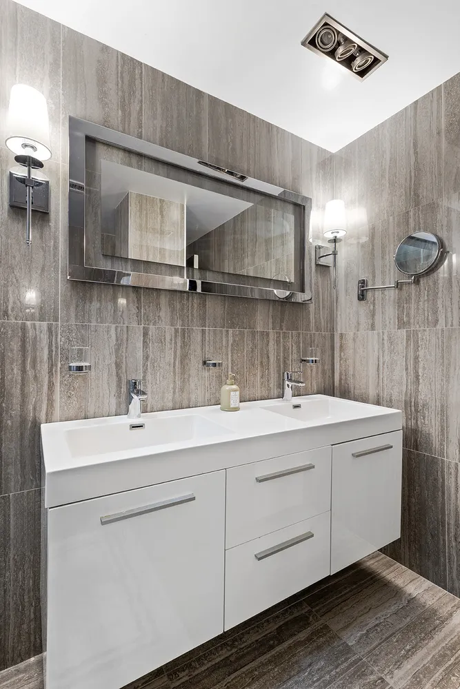 a bathroom with a sink a toilet and mirror