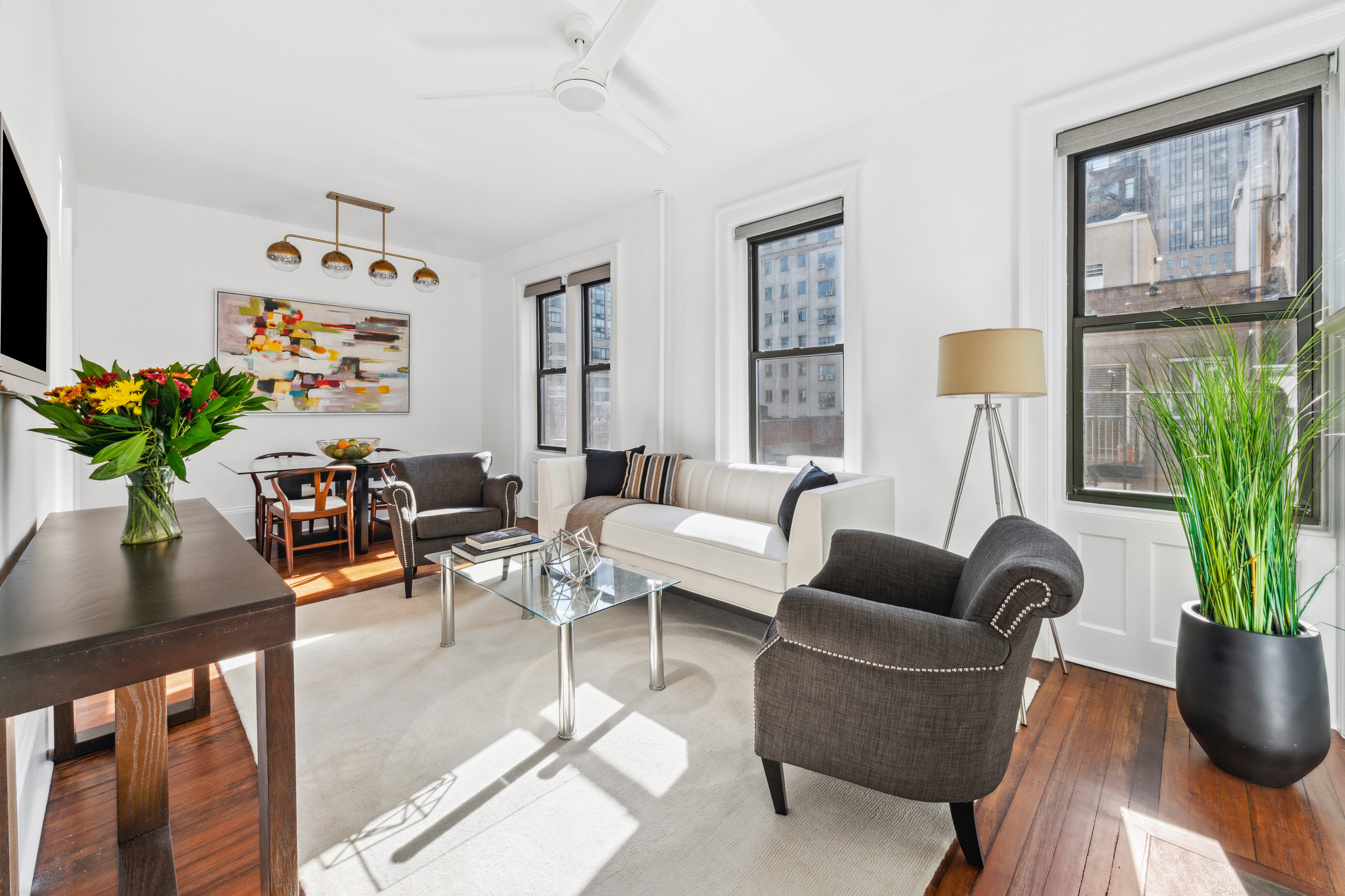 210 West 21st Street, Unit 6RE Manhattan, NY 10011 - Photo 3 of 13 a living room with furniture potted plant and a window