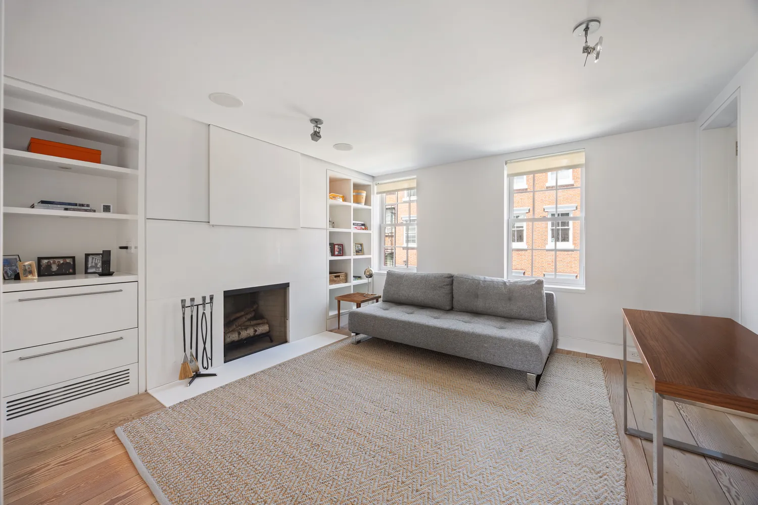 a living room with furniture and a fireplace