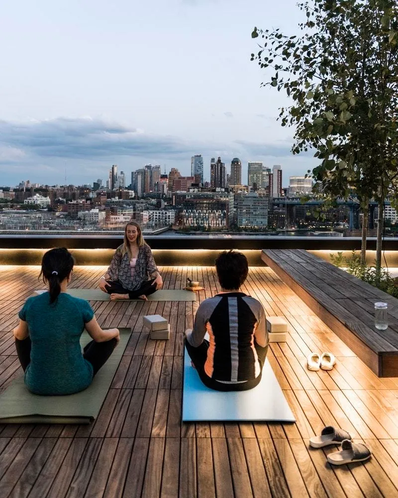a view of a roof deck with couches and wooden floor