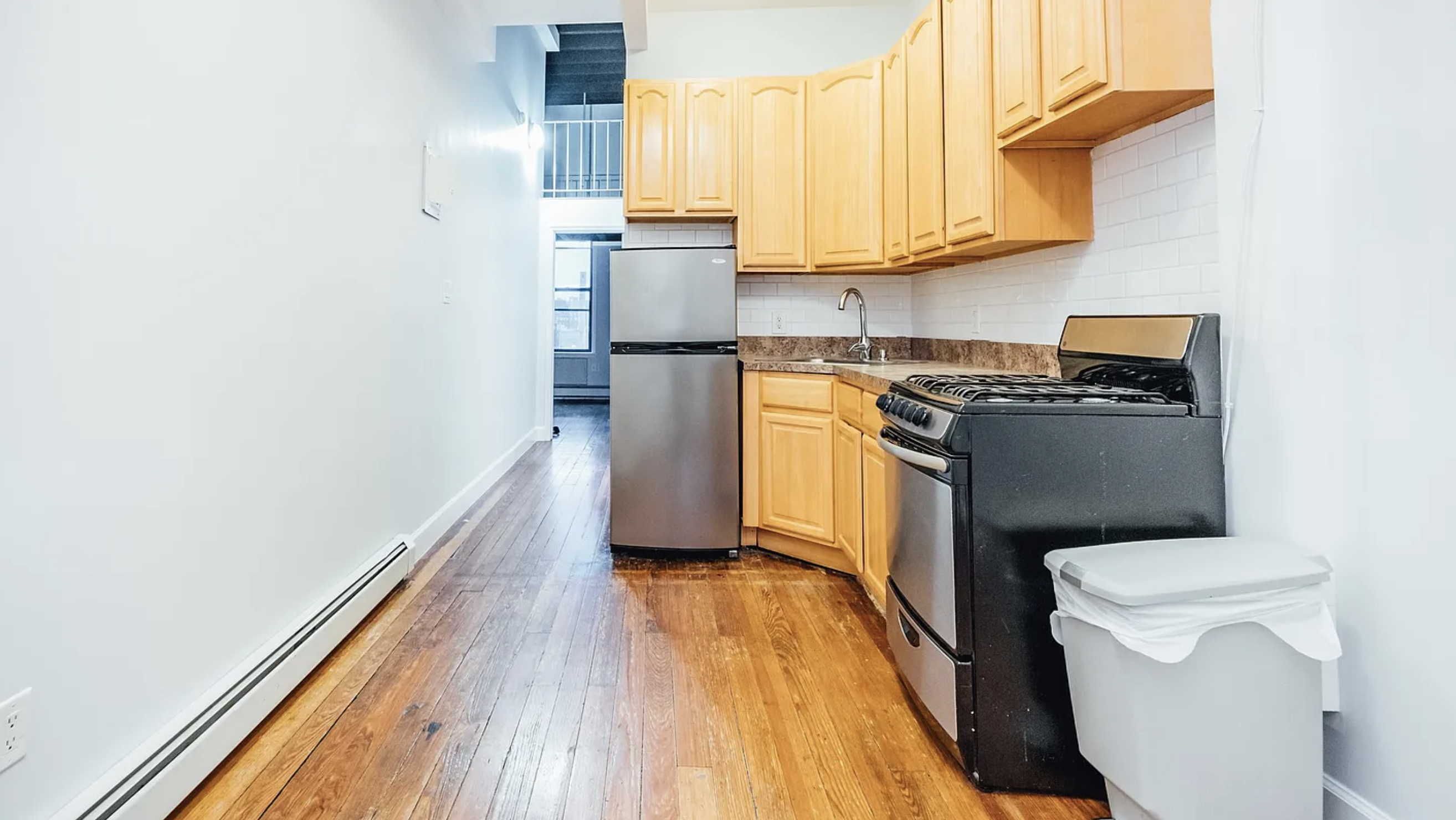 132 Jefferson Street, Unit 3L Brooklyn, NY 11206 - Photo 3 of 12 a kitchen with a refrigerator and a stove