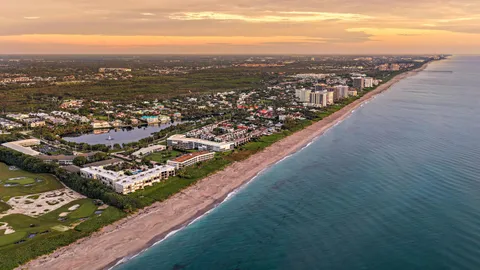 an aerial view of residential houses with city view