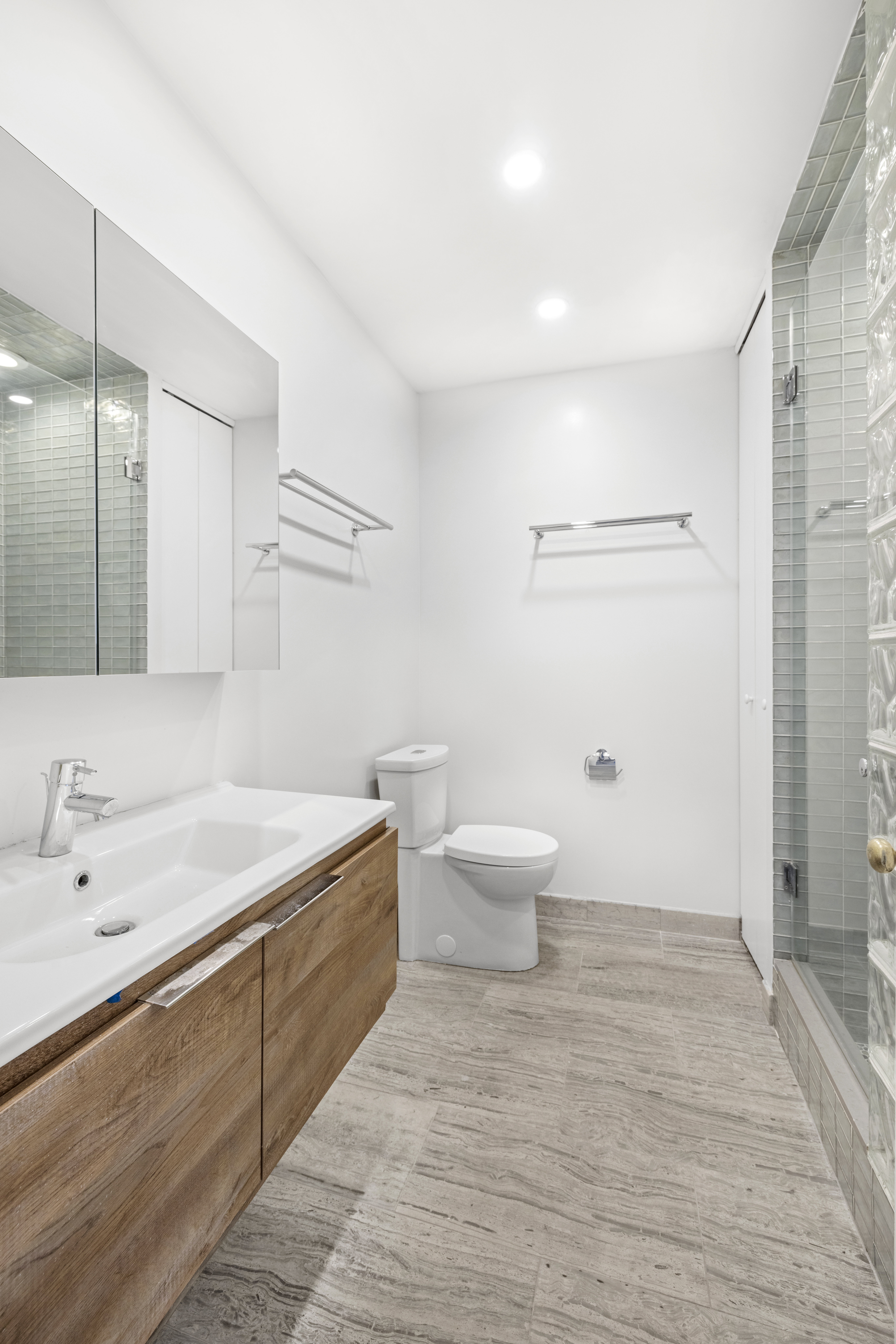 178 Sullivan Street, Unit 2A Manhattan, NY 10012 - Photo 8 of 19 a bathroom with a sink and a mirror