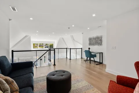 a living room with furniture and a mirror