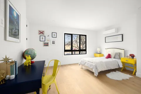 a bedroom with bed and a window