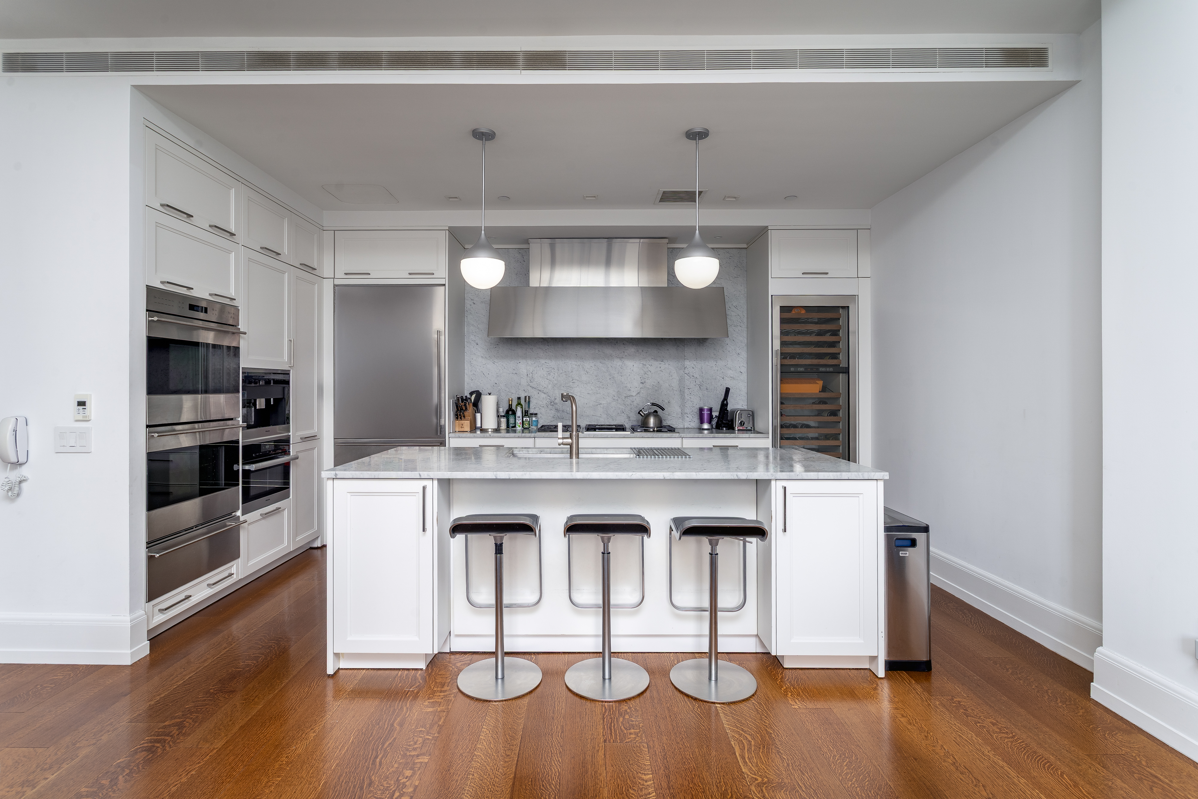 10 Madison Square West, Unit 16F Manhattan, NY 10010 - Photo 6 of 15 a kitchen with kitchen island stainless steel appliances a sink and cabinets
