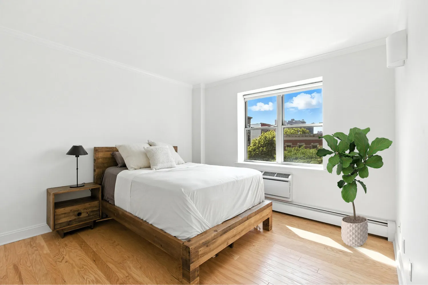 a bed sitting in a bedroom next to a window