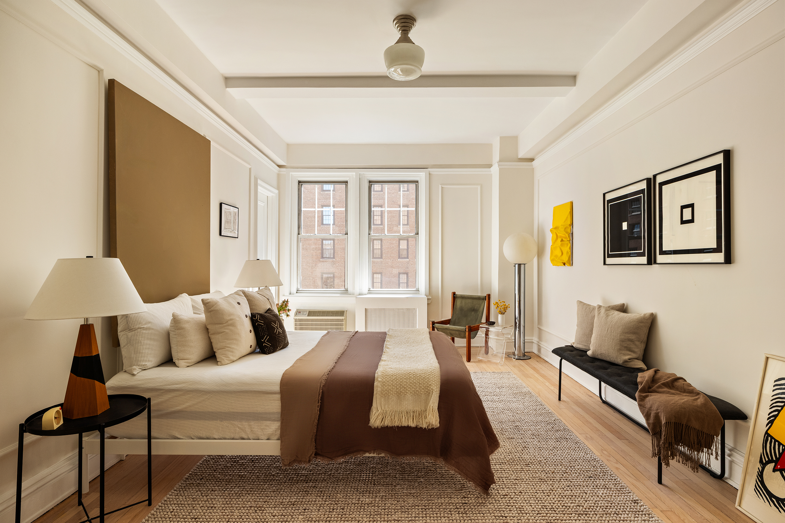 30 5th Avenue, Unit 6H Manhattan, NY 10011 - Photo 11 of 17 a bedroom with a bed wooden floor and lamp