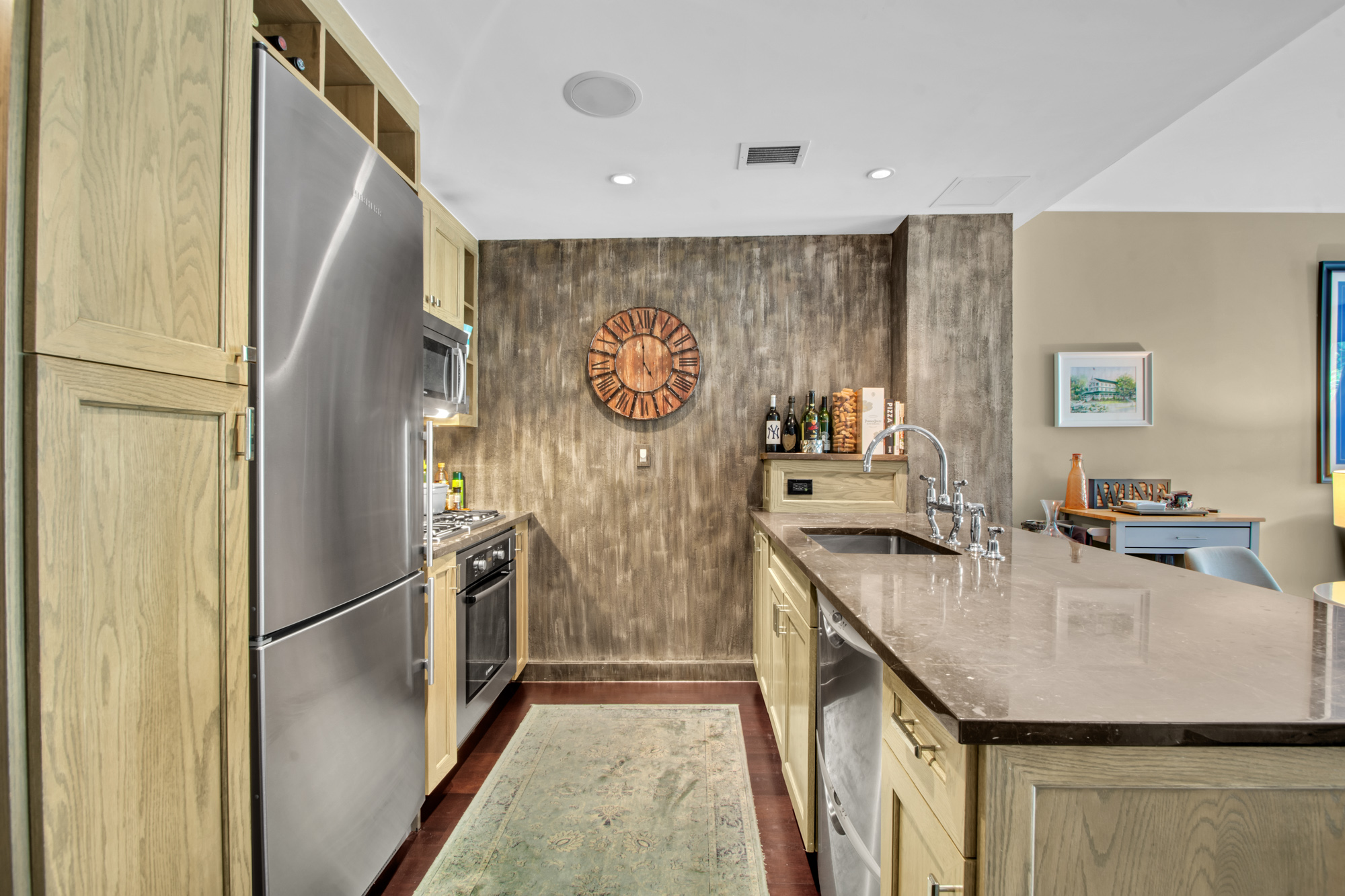 333 Rector Place, Unit 408 Manhattan, NY 10280 - Photo 3 of 12 a kitchen with stainless steel appliances granite countertop a refrigerator and a stove