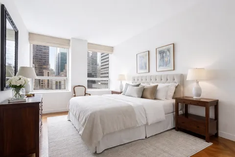 a bedroom with a bed and a night stand