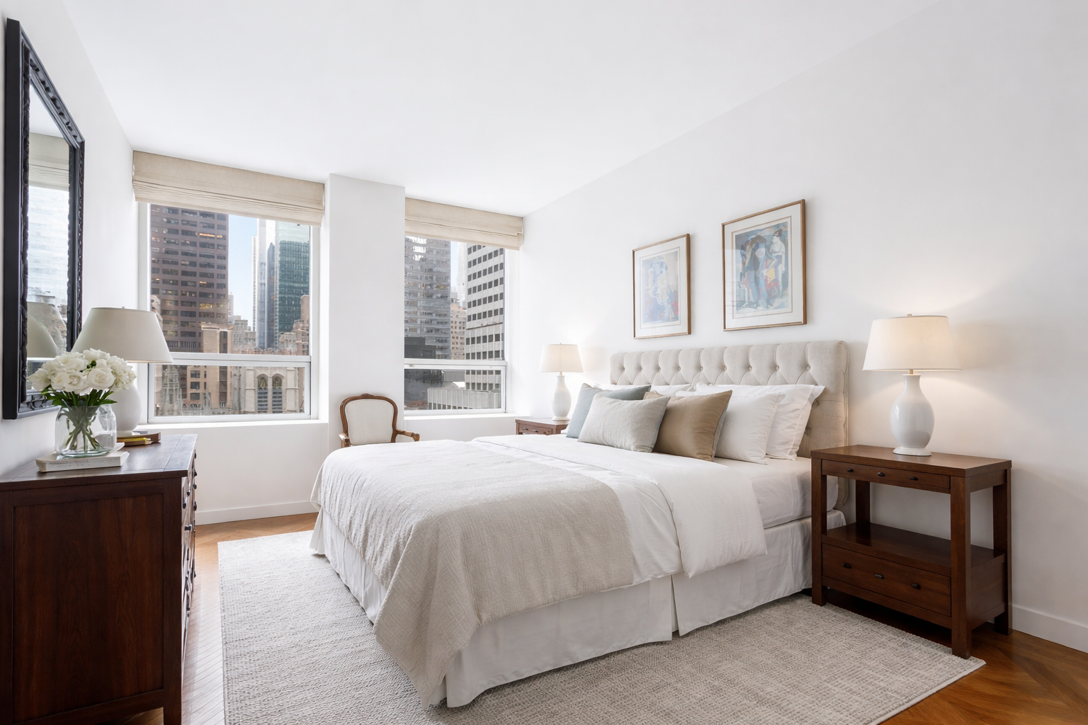15 West 53rd Street, Unit 11H Manhattan, NY 10019 - Photo 5 of 11 a bedroom with a bed and a night stand