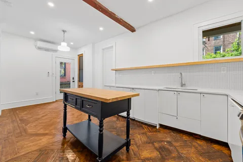 a room with wooden floor and furniture