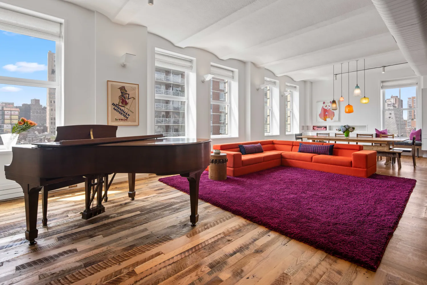 a living room with furniture a wooden floor and next to a window