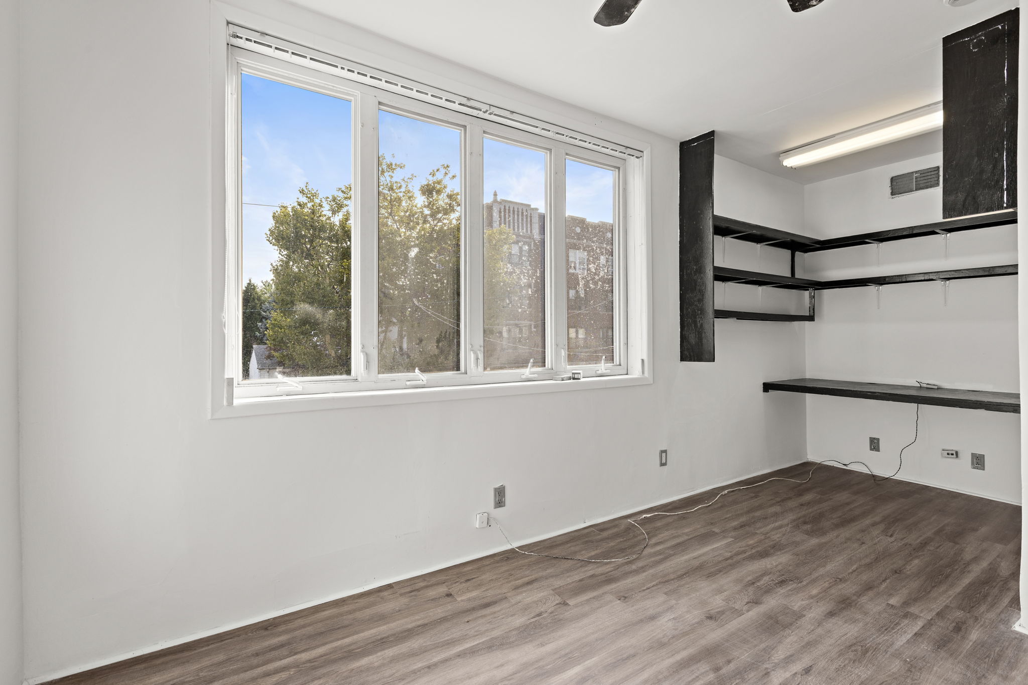 West 43rd Street Bayonne, NJ 07002 - Photo 14 of 22 a view of a room with wooden floor and windows