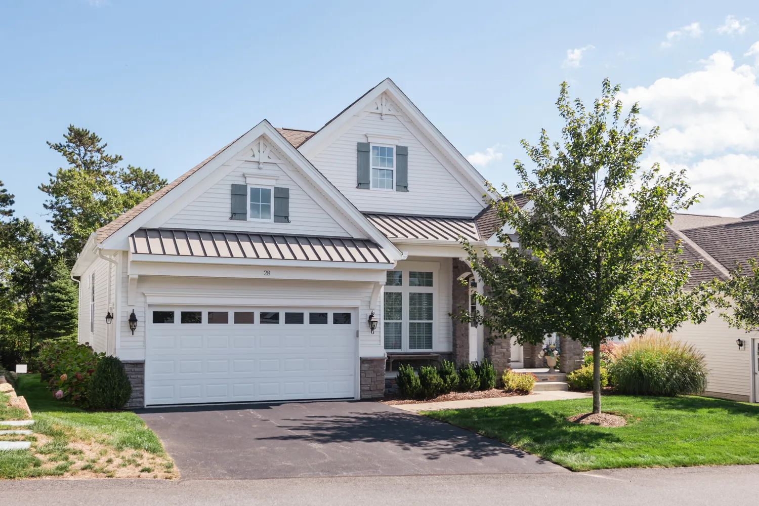 a front view of a house with a garden