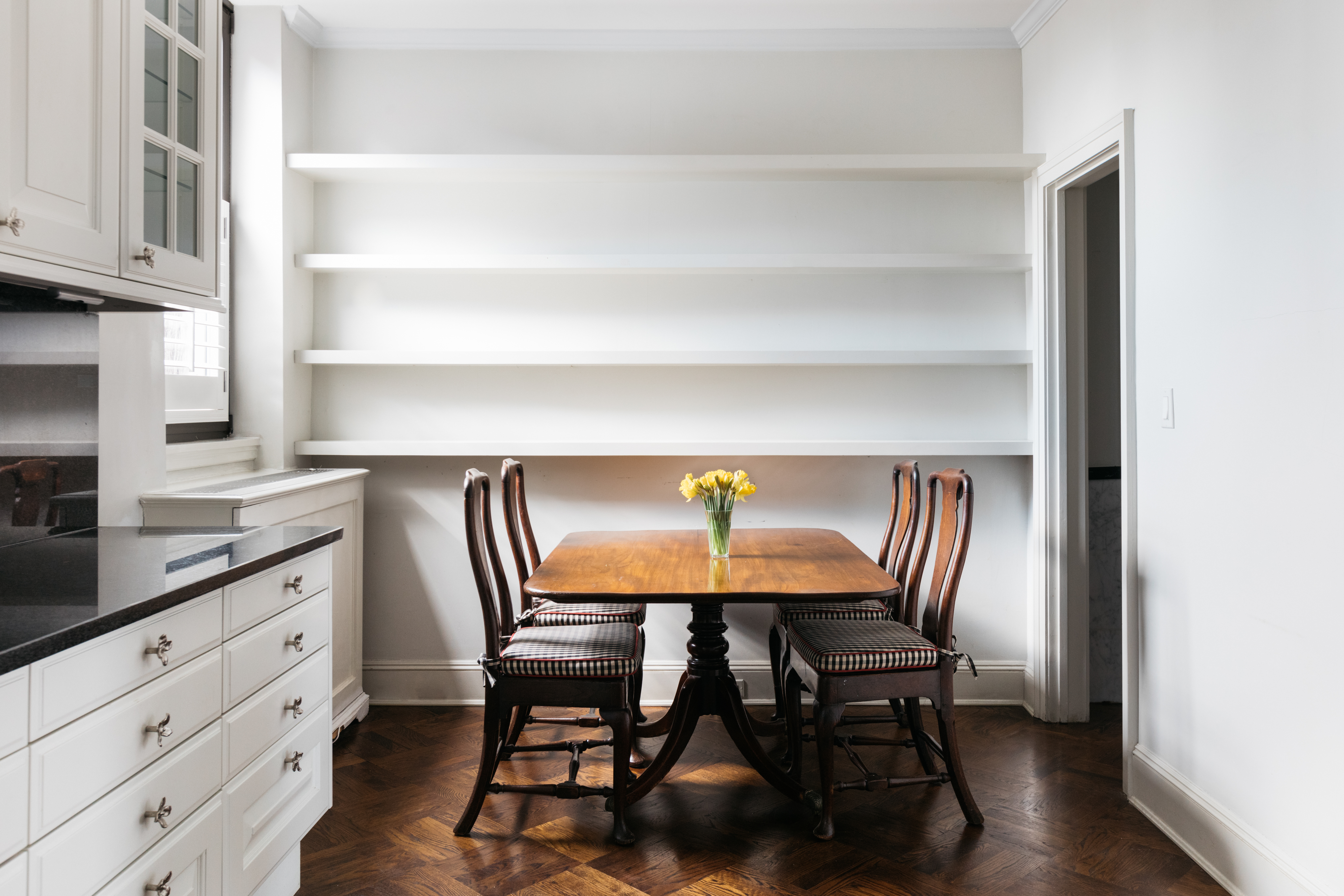 1070 Park Avenue, Unit PHE Manhattan, NY 10128 - Photo 11 of 14 a view of a dining room with furniture and wooden floor