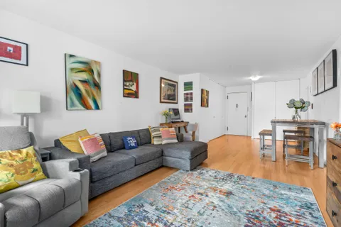 a living room with furniture and a dining table