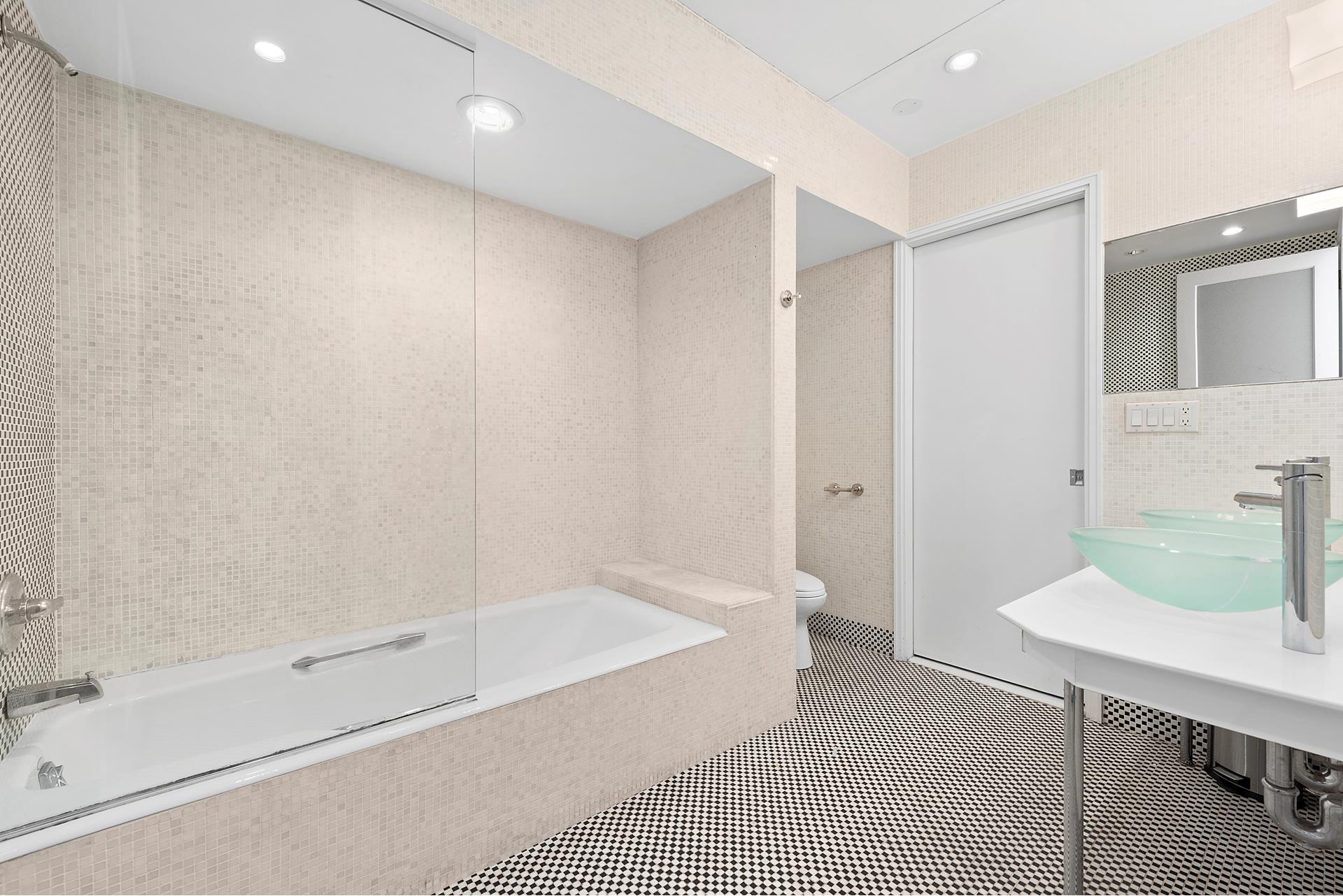 53 Murray Street, Unit 1 Manhattan, NY 10007 - Photo 11 of 15 a bathroom with a bathtub and a sink