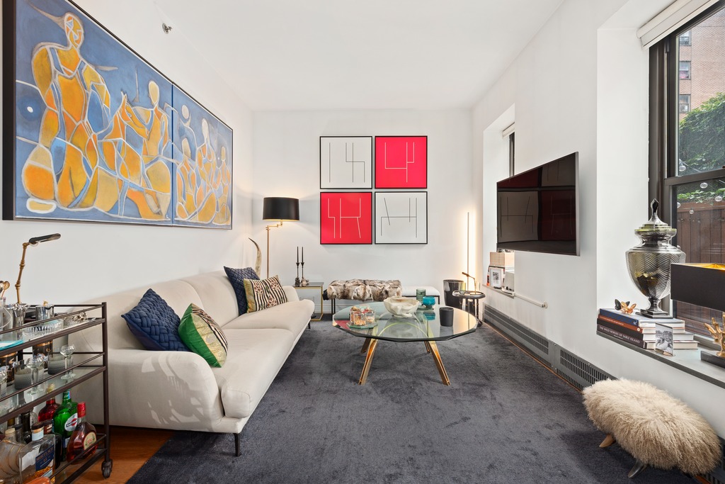 422 West 20th Street, Unit PARLOR H Manhattan, NY 10011 - Photo 11 of 16 a living room with furniture and a flat screen tv