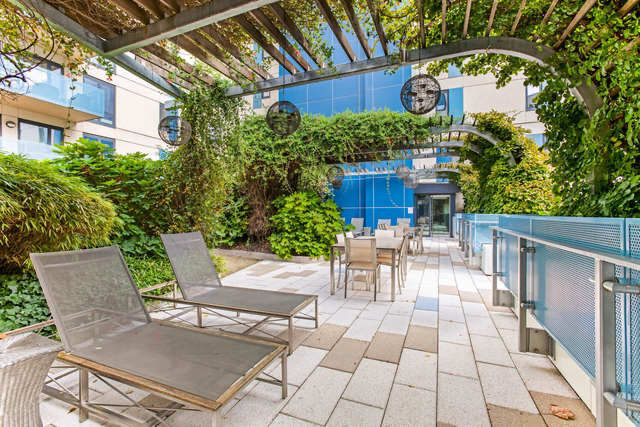 454 West 54th Street, Unit 5G Manhattan, NY 10019 - Photo 15 of 17 a view of a patio with table and chairs and potted plants