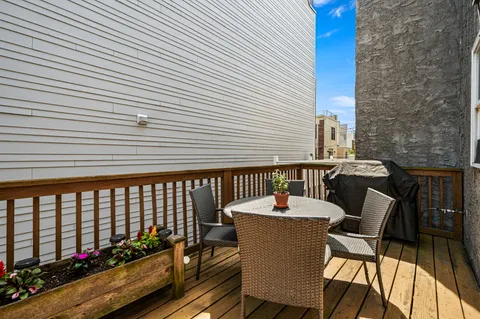 a view of a patio with a table and chairs and potted plants