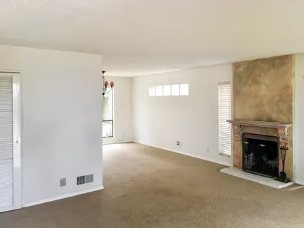 an empty room with fireplace