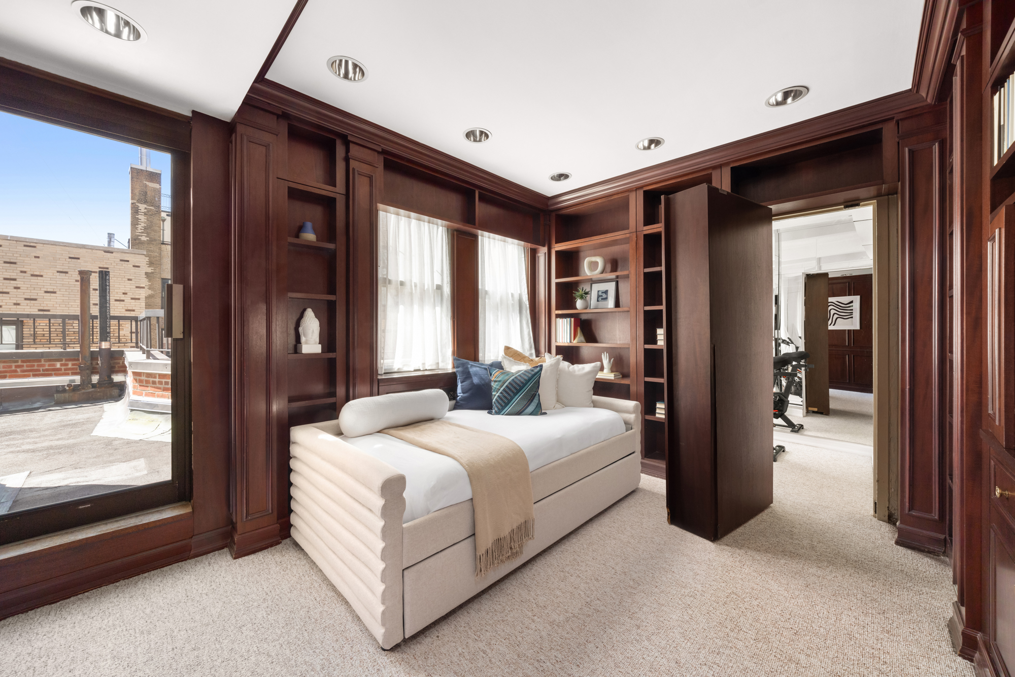 1049 Park Avenue, Unit PH Manhattan, NY 10028 - Photo 15 of 22 a spacious bedroom with a large bed and a large window